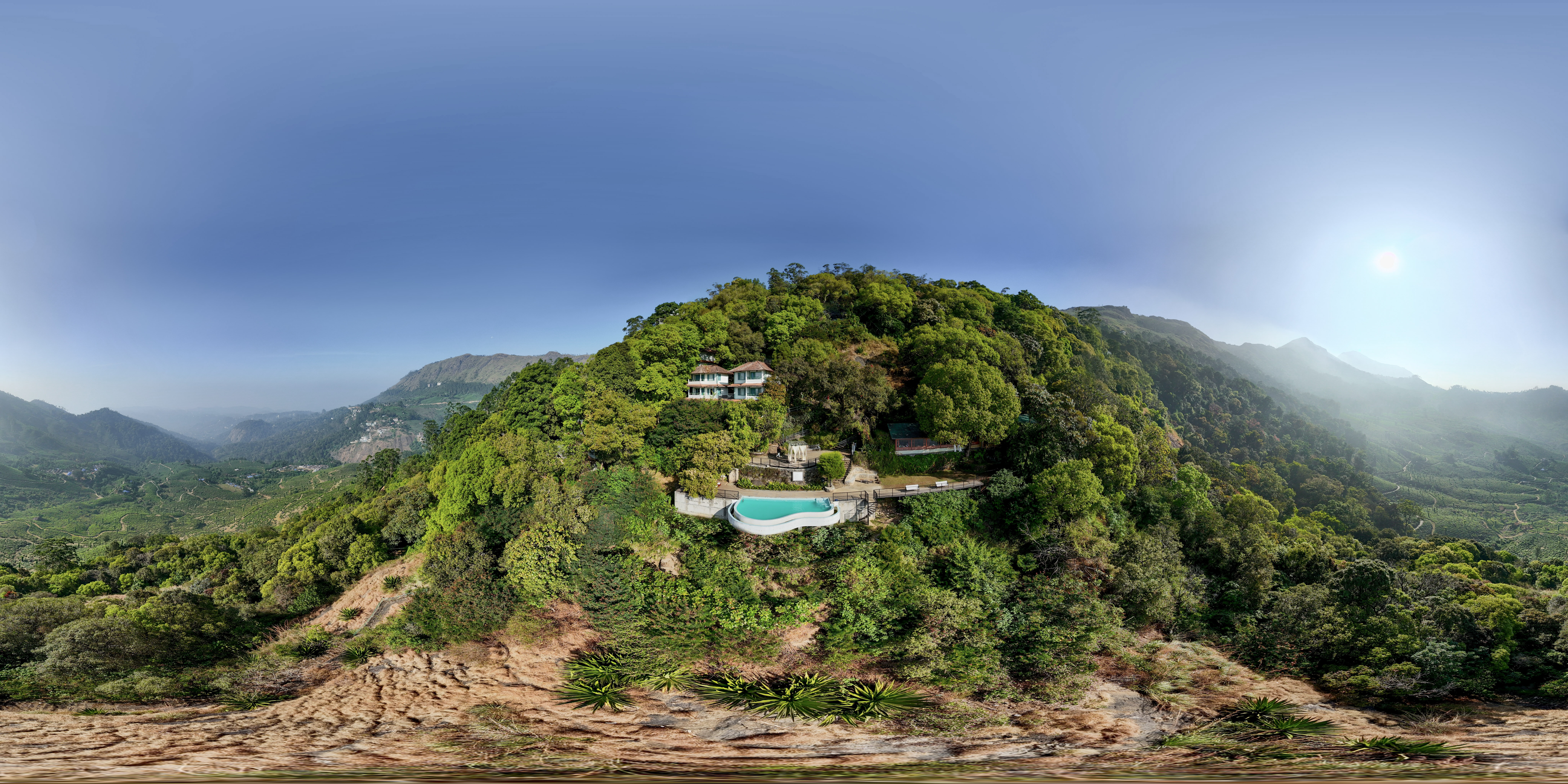 Aerial view of the pool and resort buildings at Blackberry Hills Munnar
