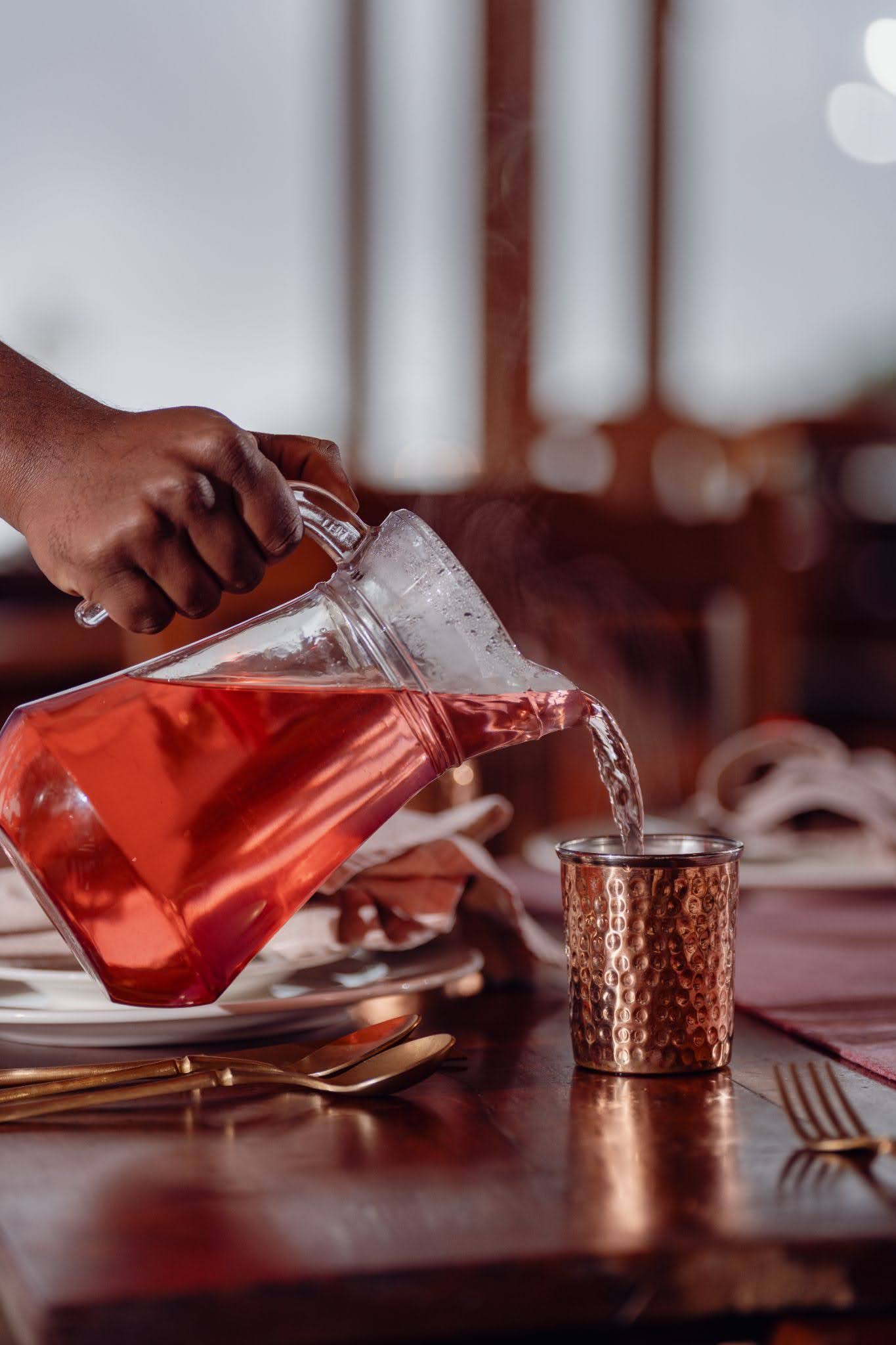 Herbal water served in a copper tumbler at Hornbill Restaurant