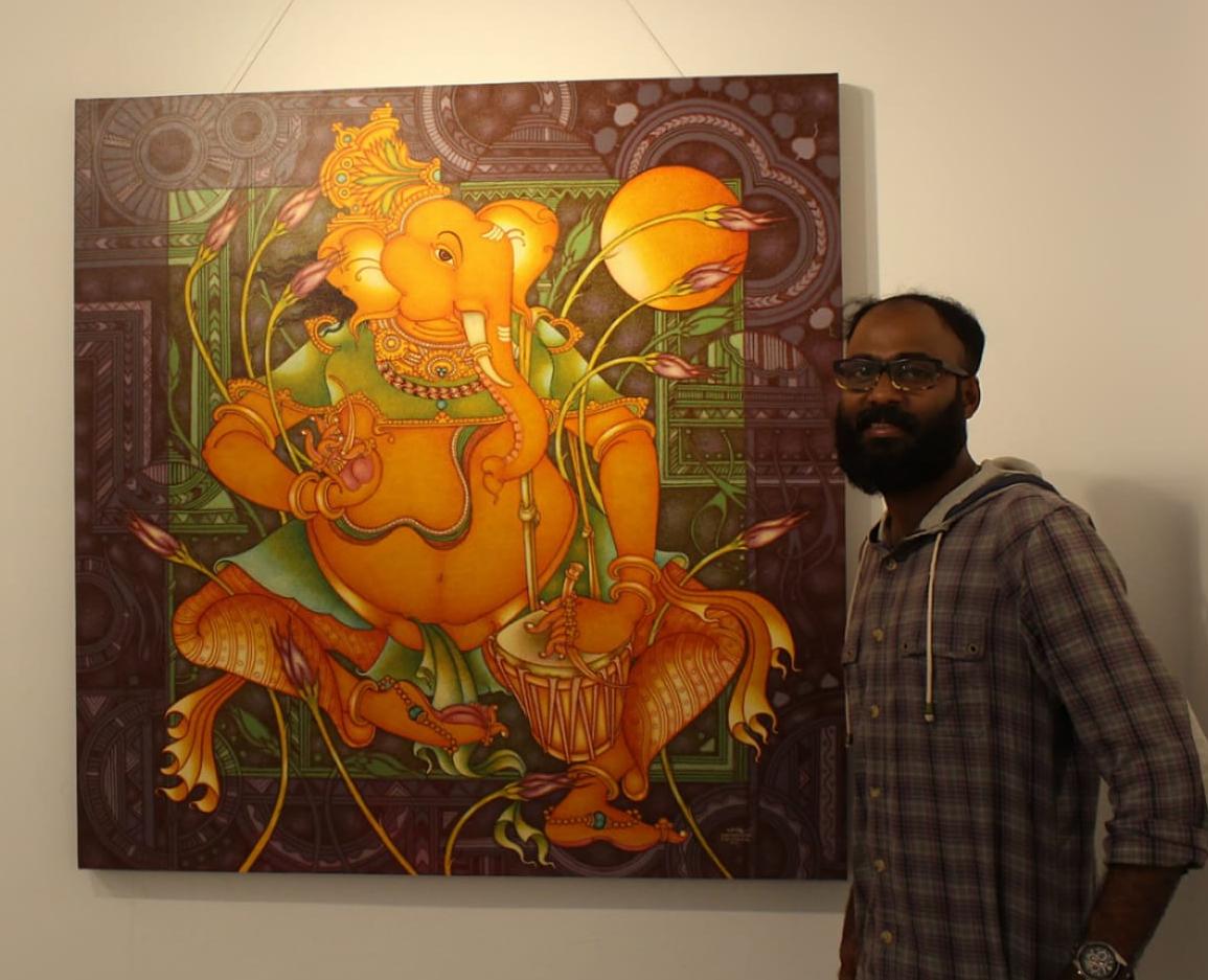 Artist Manikandan Punnakkal with a Kerala mural painting