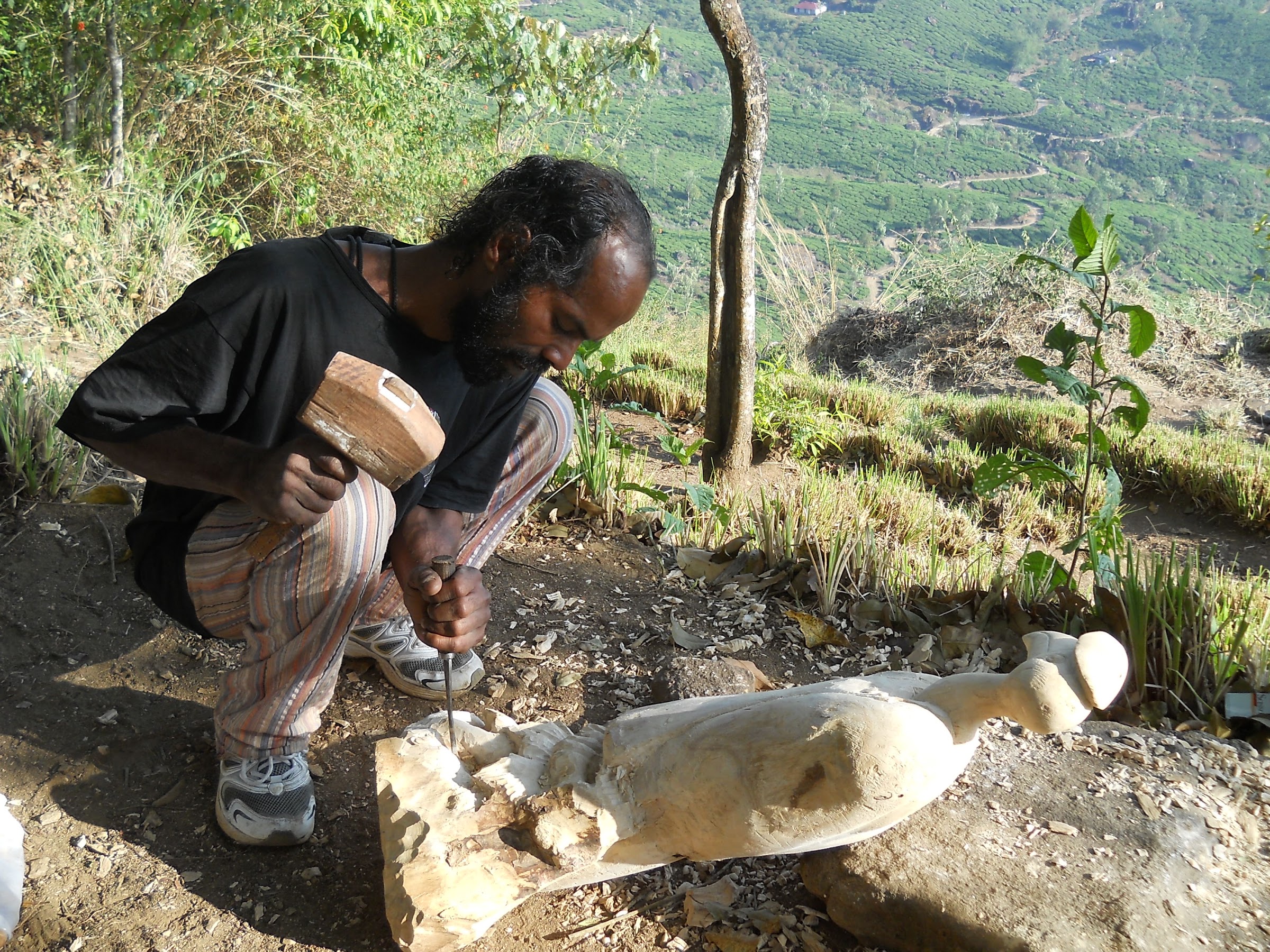 Sunil Raghavan carving a hornbill wood sculpture at Blackberry Hills Munnar